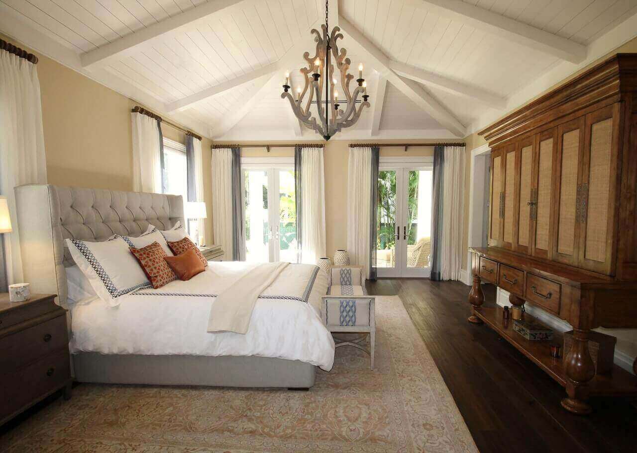 bedroom with chandelier and wood ceiling beams